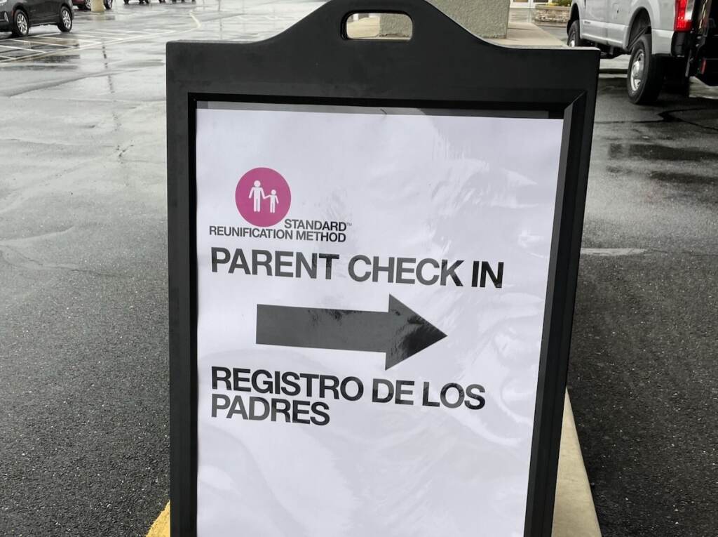A sign reads "Parent check-in" and "Registro de los padres"