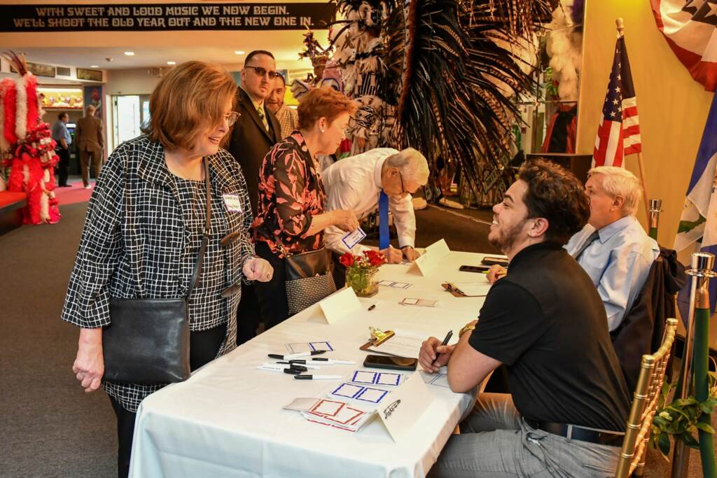 Checking in to the 50th anniversary party for Dignity Philadelphia, held May 2023 at the Mummers Museum