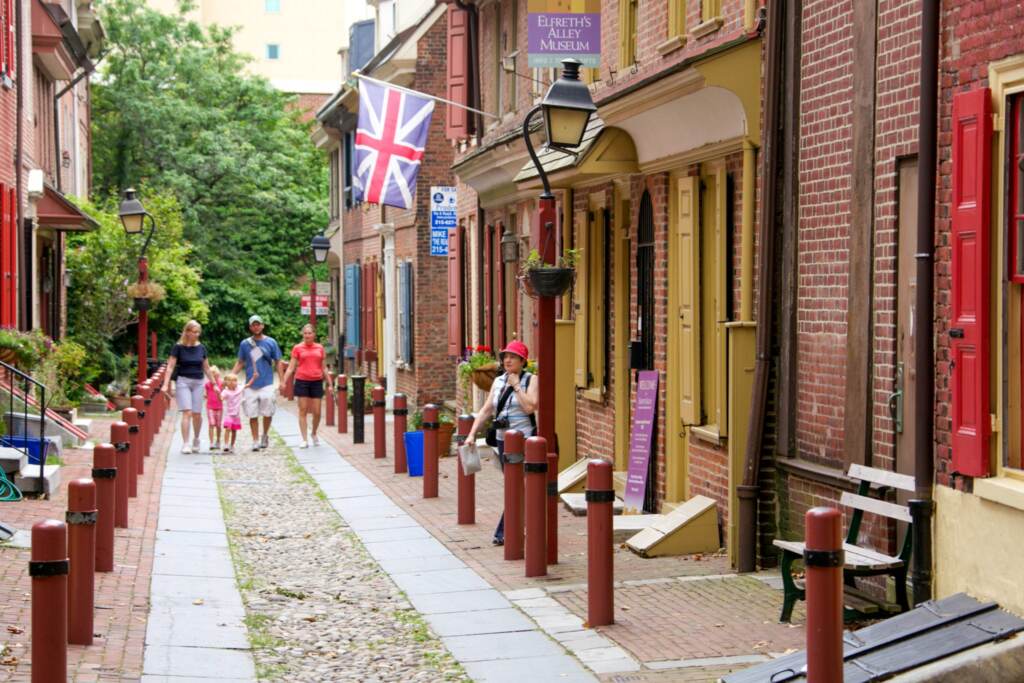 Elfreth's Alley, an historic street in Philadelphia with cobblestones paving the road, is visible.