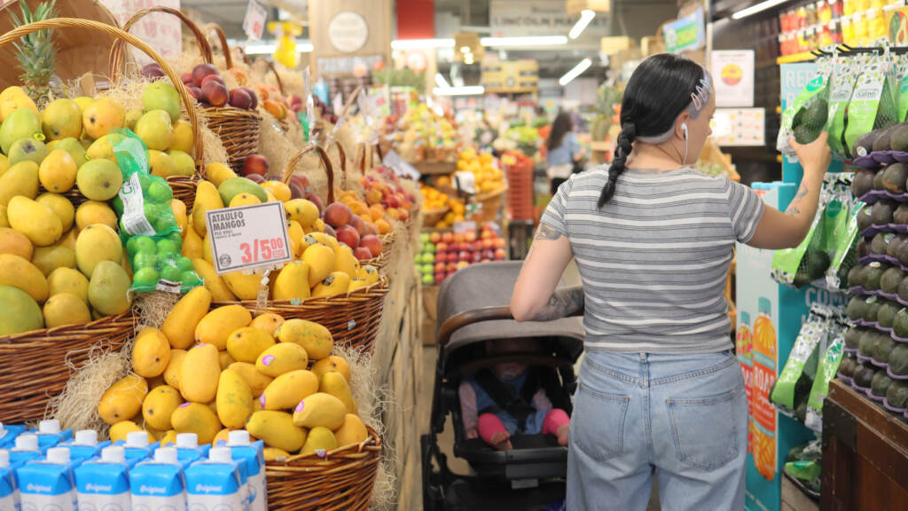 People shop at a market in Brooklyn, New York City, on June 12, 2023. A woman shopping in a supermarket