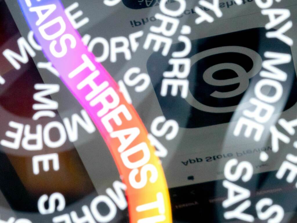 A photo illustration shows the logo for Meta’s Threads, an app that gained over 10 million users overnight. Lines reading