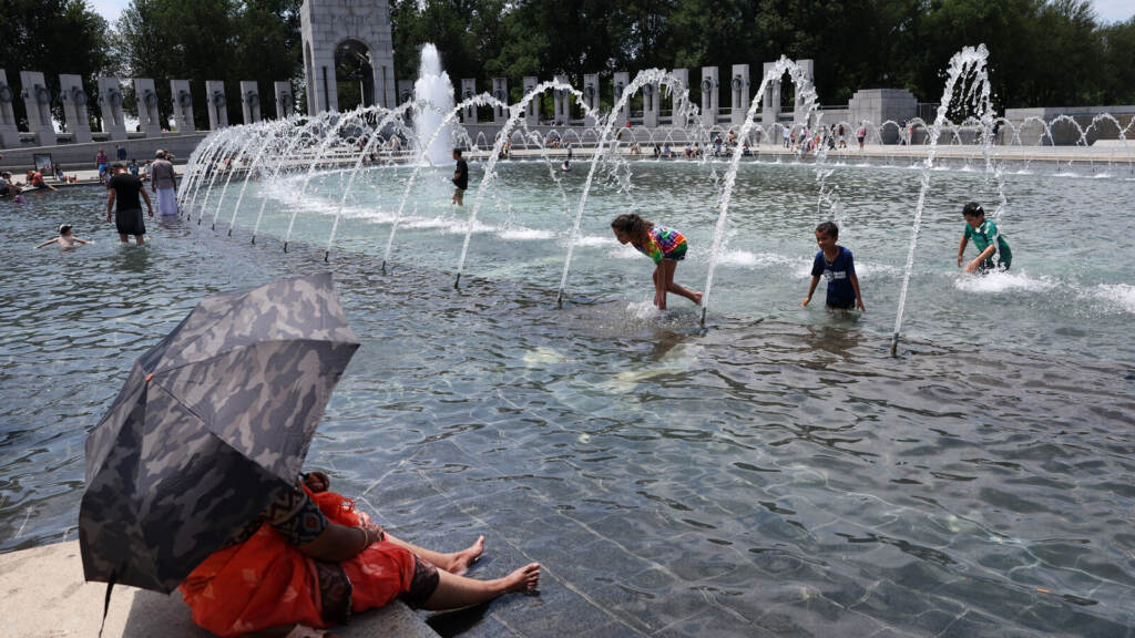 Amid Sweltering Heat, People Cool Down In Washington DC Kids play in a fountain.