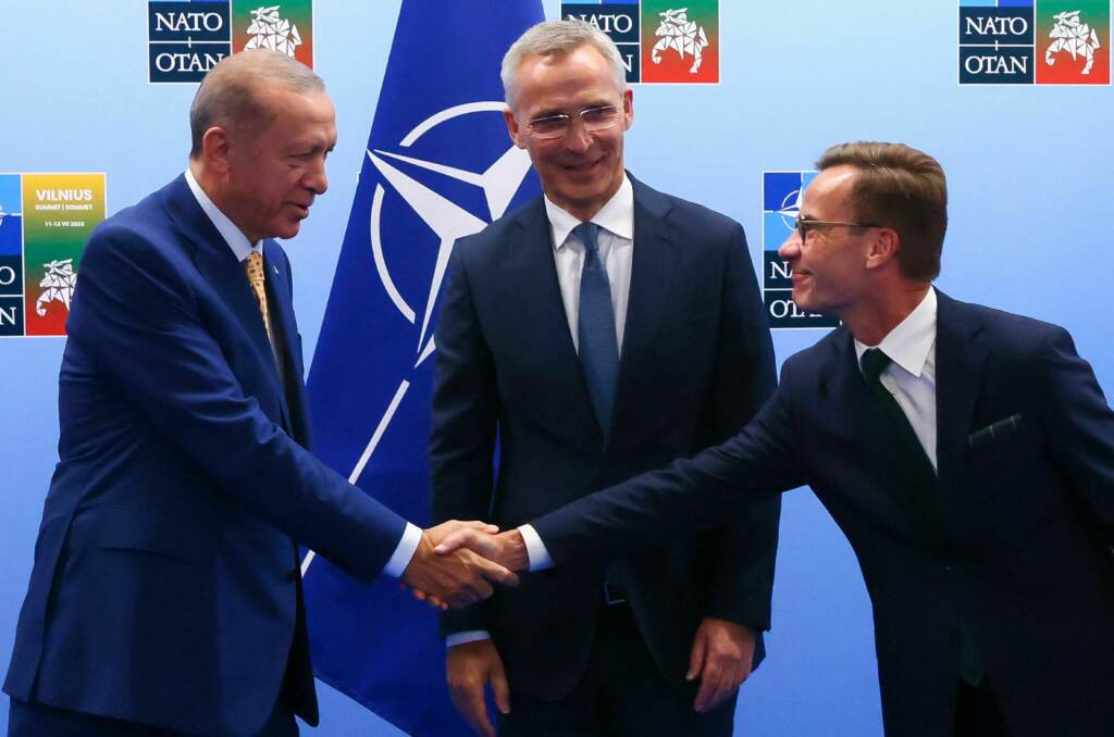Turkish President Tayyip Erdogan (left) and Swedish Prime Minister Ulf Kristersson shake hands in front of NATO Secretary-General Jens Stoltenberg prior to their meeting, on the eve of a NATO summit, in Vilnius, Lithuania, on Monday. urkish President Tayyip Erdogan (left) and Swedish Prime Minister Ulf Kristersson shake hands in front of NATO Secretary-General Jens Stoltenberg prior to their meeting, on the eve of a NATO summit, in Vilnius, Lithuania, on Monday. (Yves Herman/Pool/AFP via Getty Images)