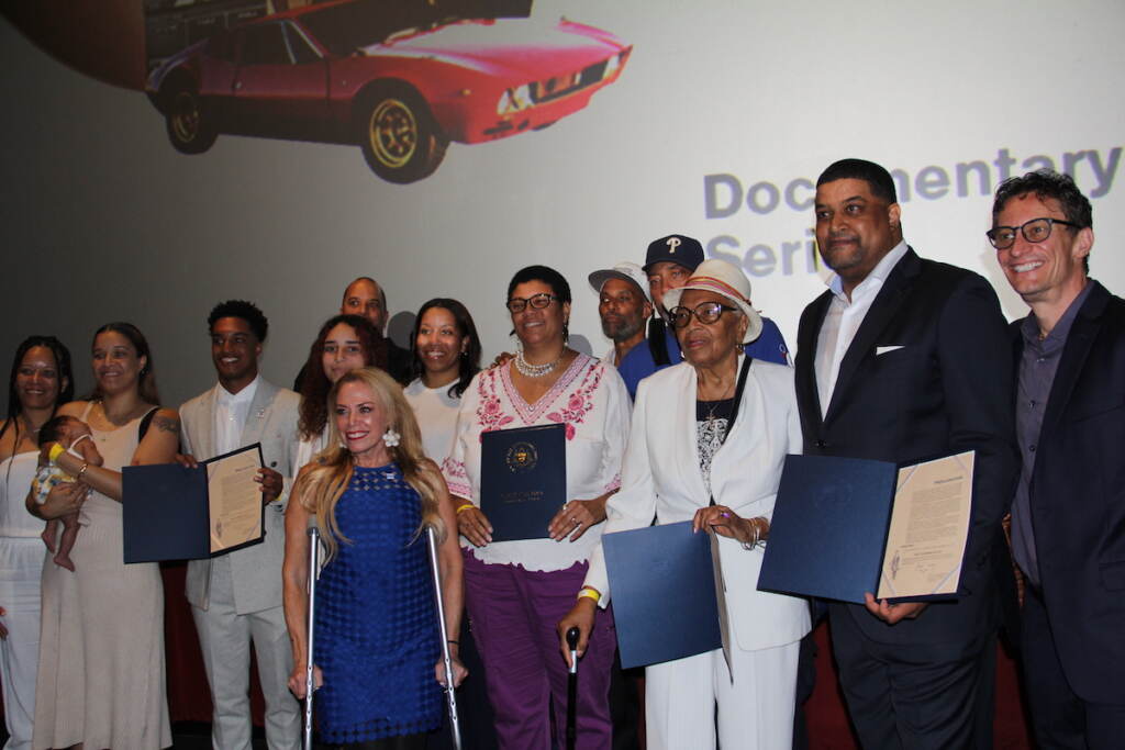 City Representative Sheila Hess, members of Chamberlain's family, and people who worked on Goliath pose for a group photo