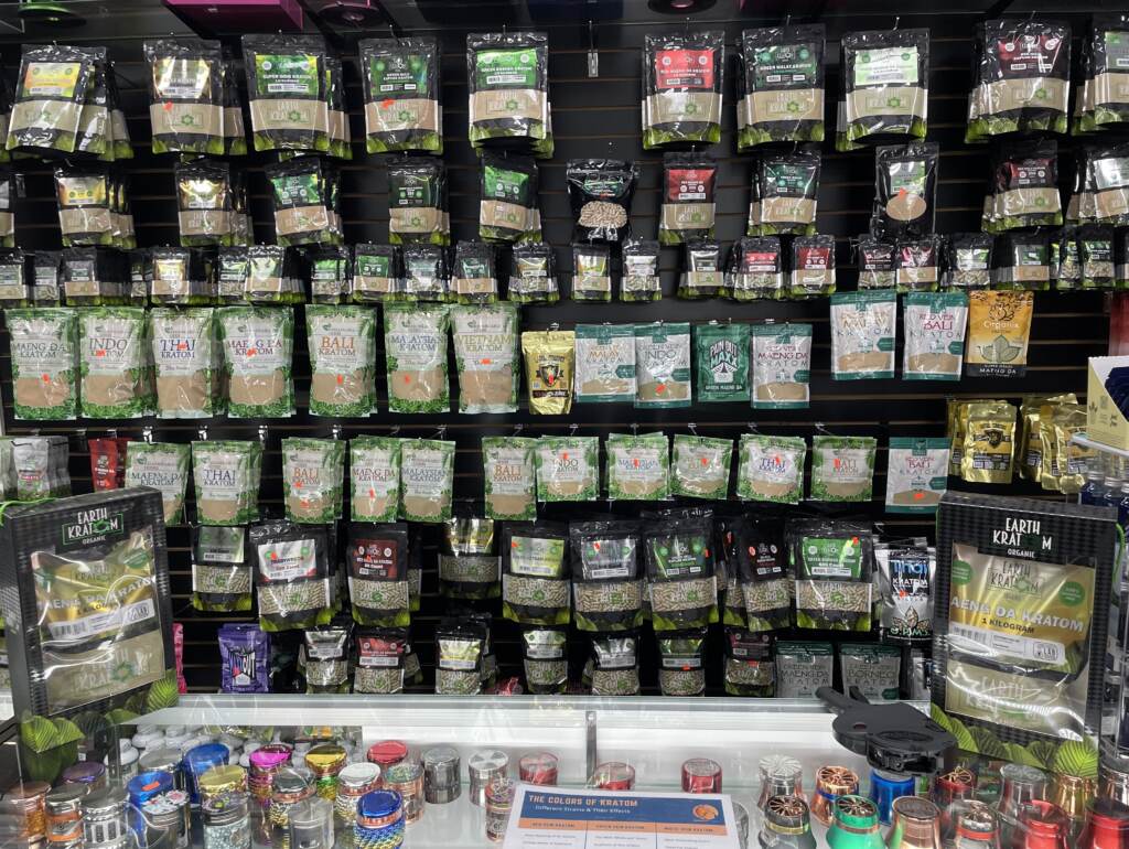 Shelves festooned with kratom powders, capsules, liquids and extracts greet customers at Tifton Tobacco & Vapor in Tifton, Ga. Kratom is a billion-dollar business in the U.S., according to the American Kratom Association. Shelves festooned with kratom powders, capsules, liquids and extracts