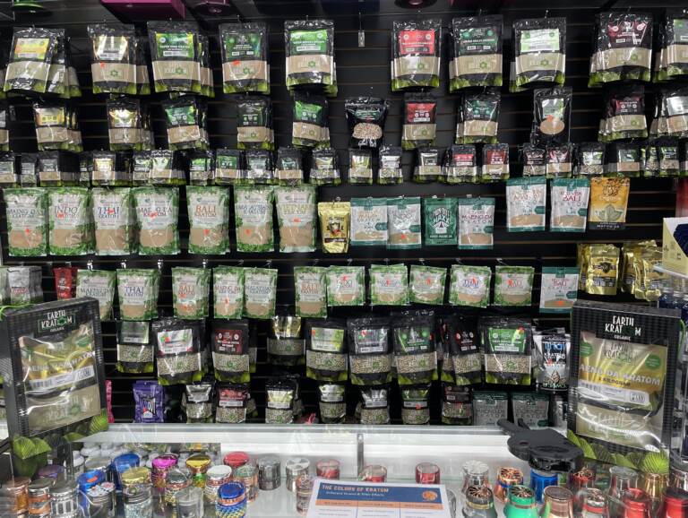 Shelves festooned with kratom powders, capsules, liquids and extracts