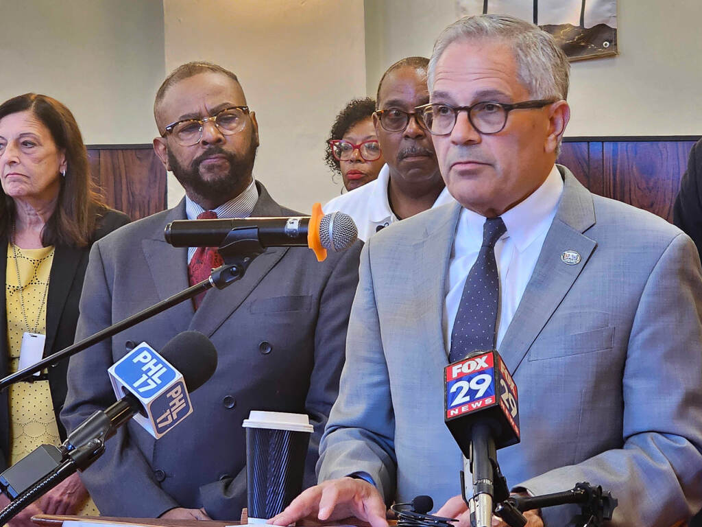 Larry Krasner speaking at a podium