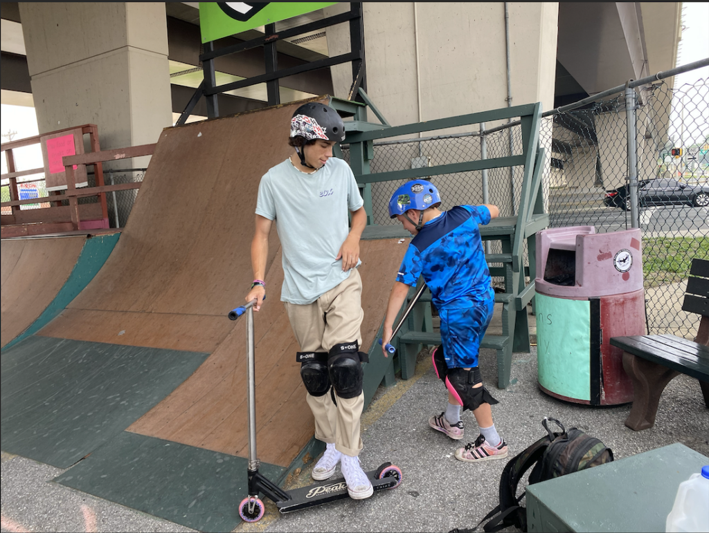 Mickey Tomchick and Jase Bryck on scooters