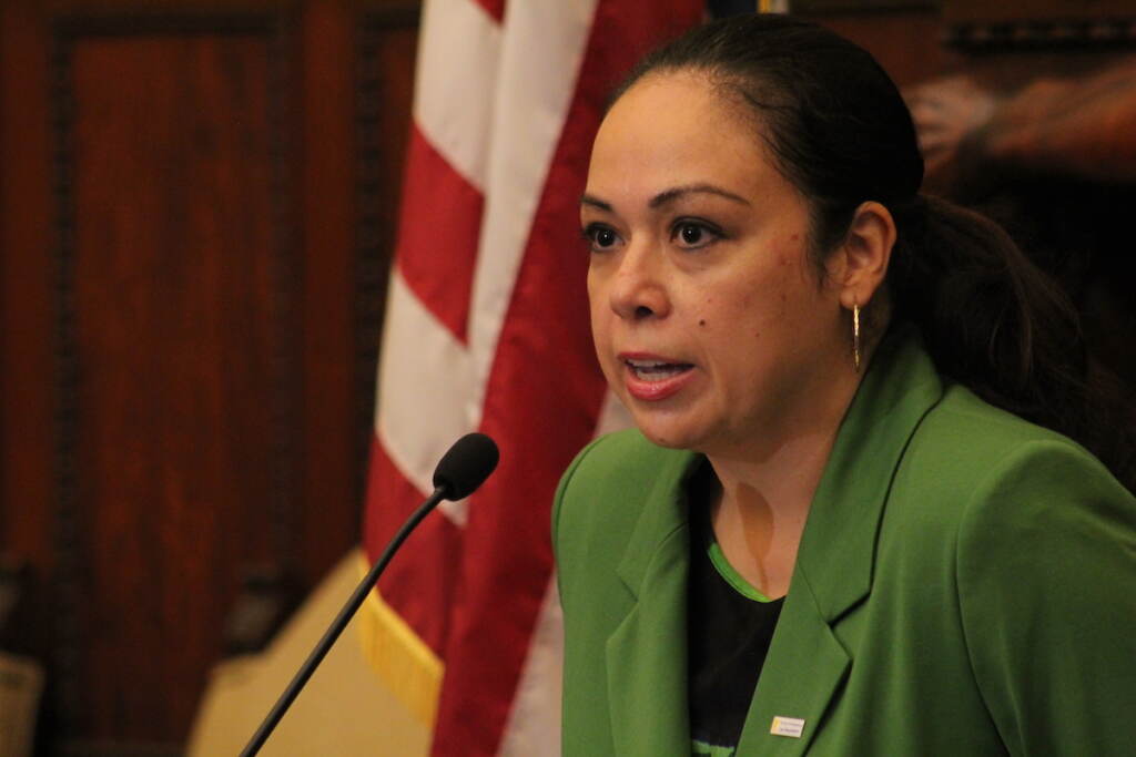 City Solicitor Diana Cortes speaks into a microphone.