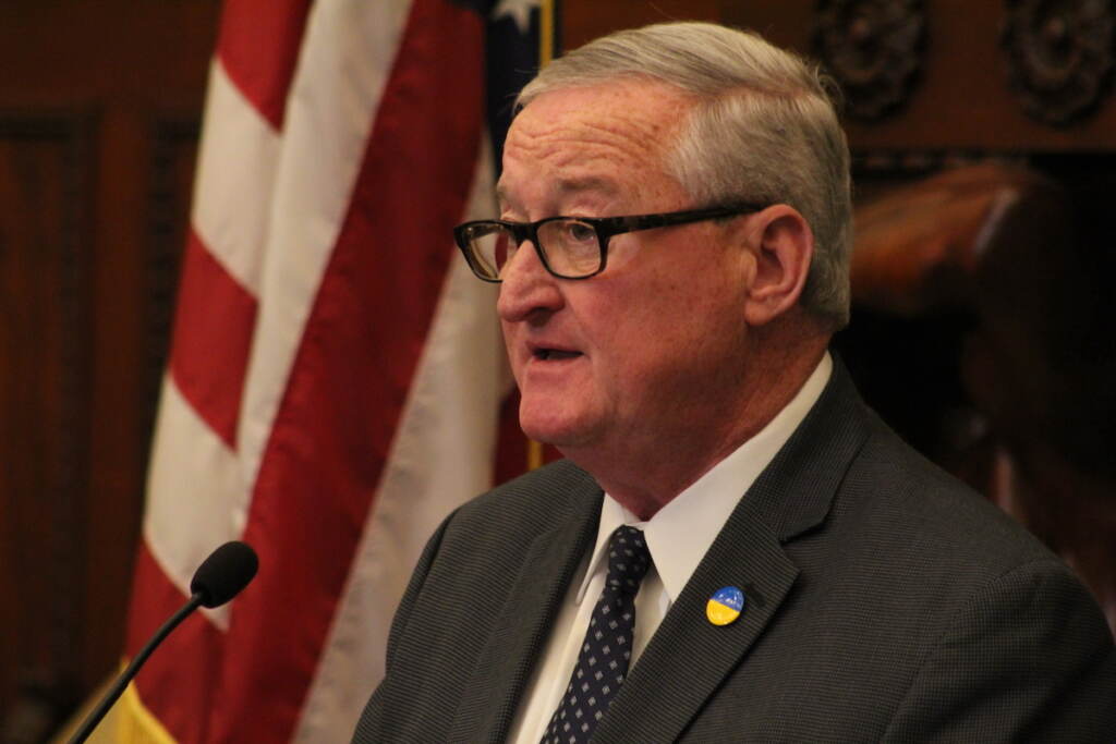 Mayor Jim Kenney speaks into a microphone.