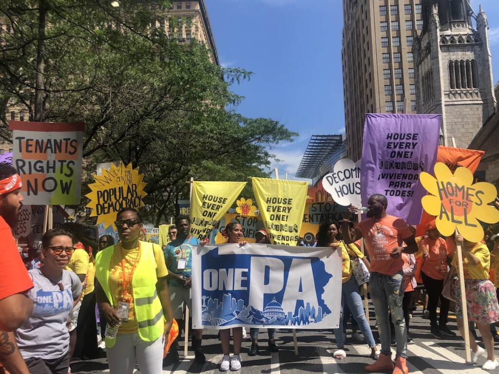 philly-housing-rally-2 People hold signs as they march, demanding affordable housing for all.