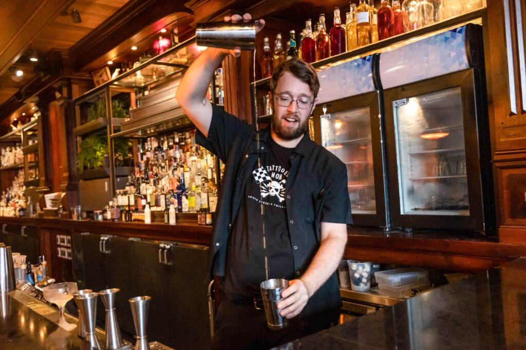 Post Haste co-owner and beverage creator Fred Bebee mixes a drink at the Post Haste bar.