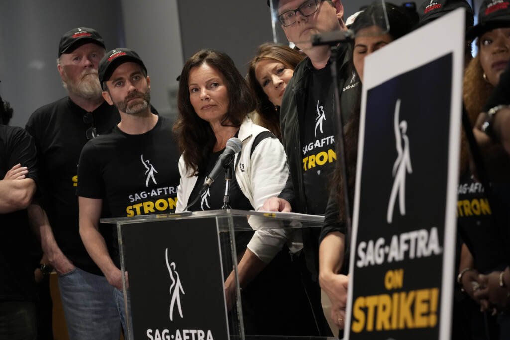 SAG-AFTRA president Fran Drescher, center, and SAG-AFTRA National Executive Director and Chief Negotiator Duncan Crabtree-Ireland, center right speak alongside SAG-AFTRA members during a press conference announcing a strike by The Screen Actors Guild-American Federation of Television and Radio Artists on Thursday, July, 13, 2023, in Los Angeles.