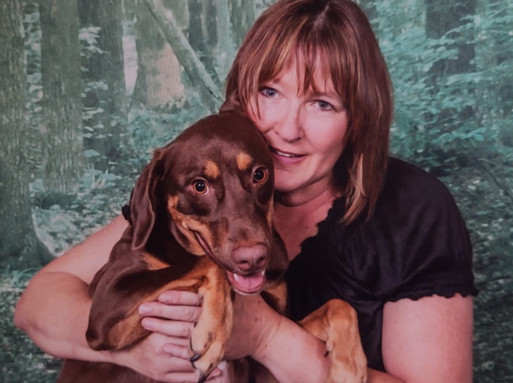 Susan Barnhart is seen hugging a dog