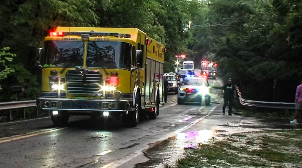 Vehicles are seen at the scene of extreme flooding in Upper Makefield Township