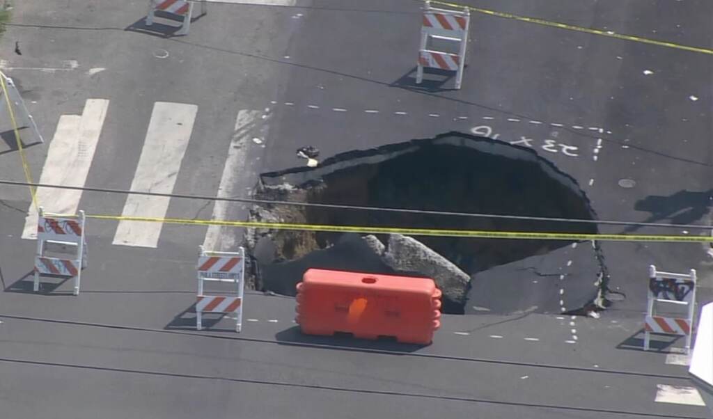 west-philly-sinkhole-6abc-2023-07-26 Large sinkhole in the middle of the intersection.