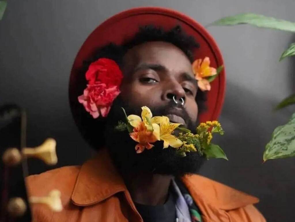 yeho-bostick-11 A portrait of Yeho Bostick, posing for a photo with flowers in his beard.