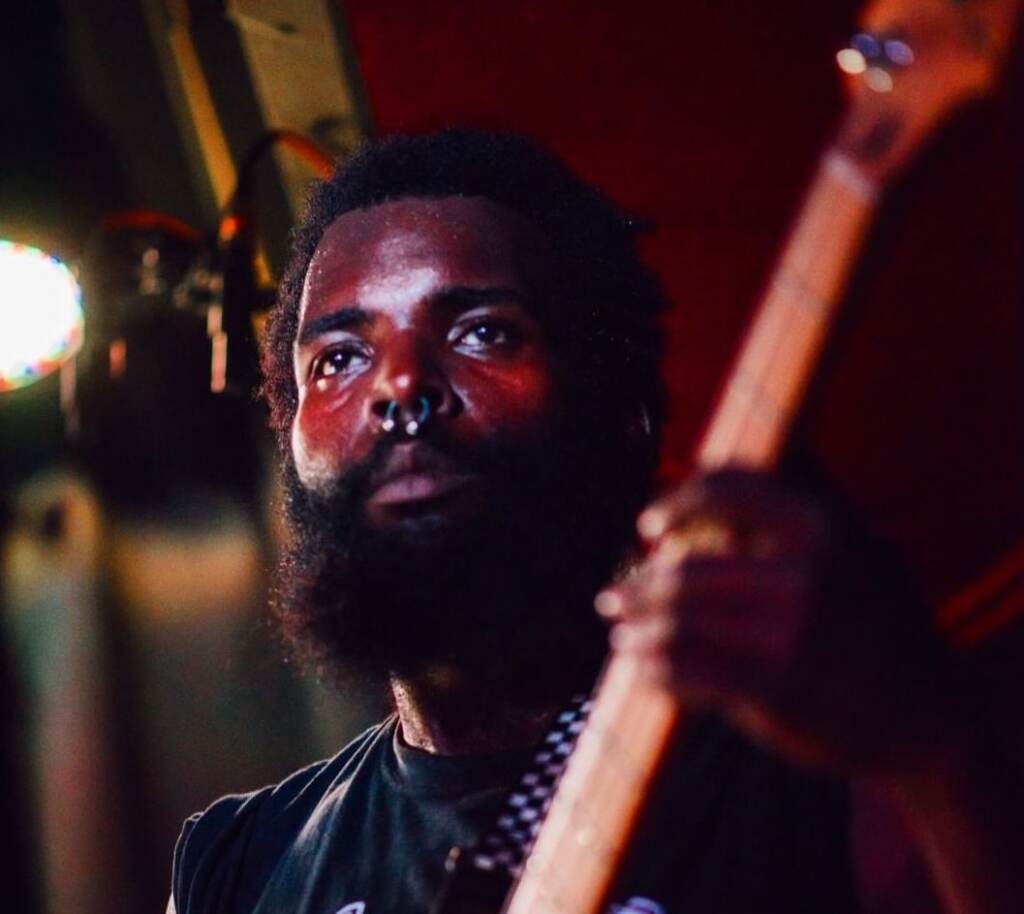 Yeho Bostick plays guitar