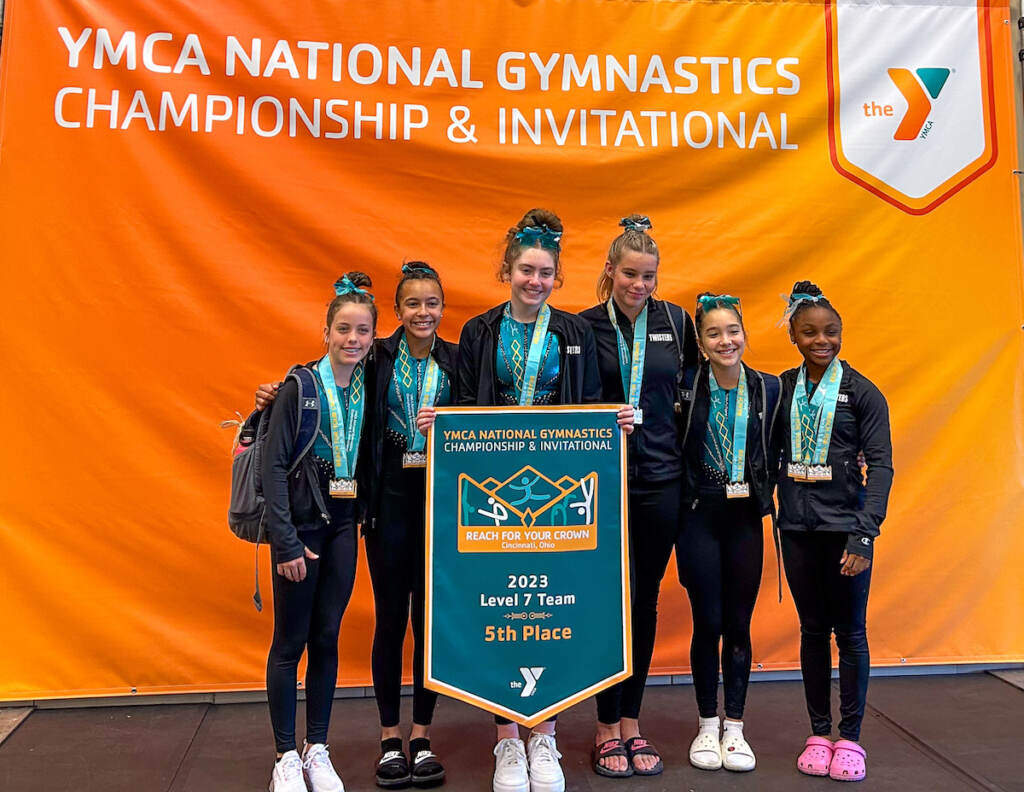 ymca-4 A team of gymnasts poses for a photo.