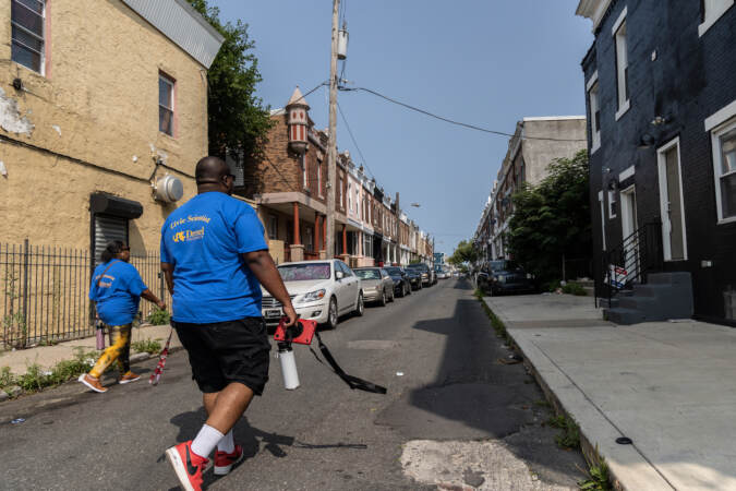 Jalen Busbee (right) and Stephanie Scott (left) walk down a street.