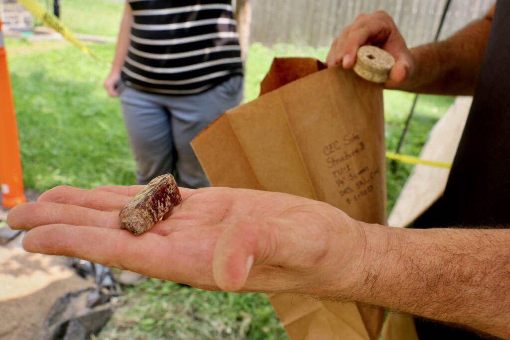 A close-up of a fragment of an artifact held in Doug Smit's hand.