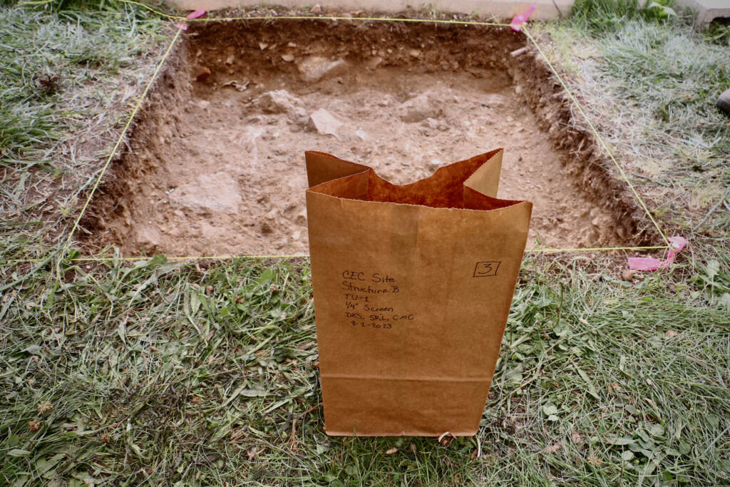 A view from above of a one meter square hole in the ground.