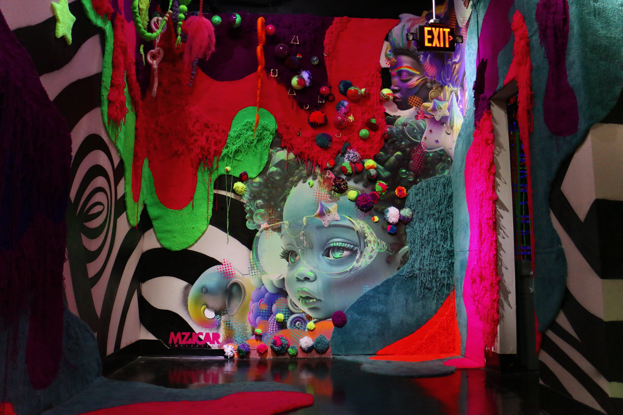 An elaborate brightly colored and designed room with a human face visible in a swirling design