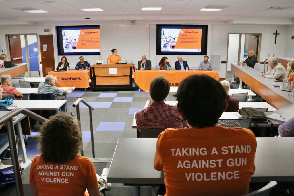 A view from the back of the room at a town hall meeting.