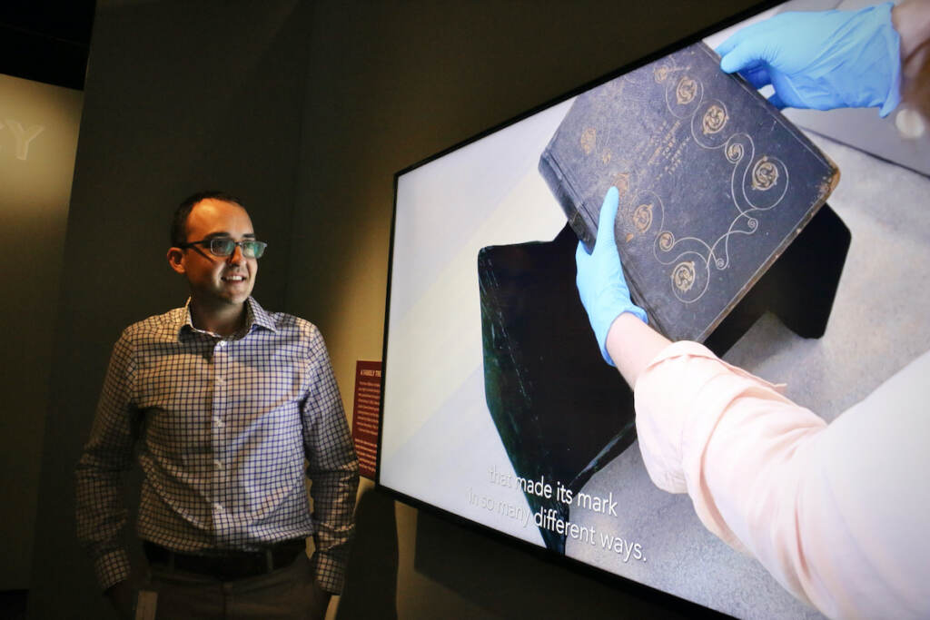 Museum of the American Revolution curator Matthew Skic stands beside a video telling the history of the Forten family Bible