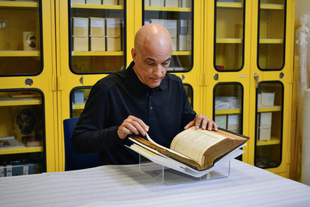 2023 08 16-provided-kip forten jacobs-philadelphia museum of the american revolution-forten family bible Atwood ''Kip'' Forten Jacobs, the great-great-great-great-grandson of James Forten, pages through the family Bible