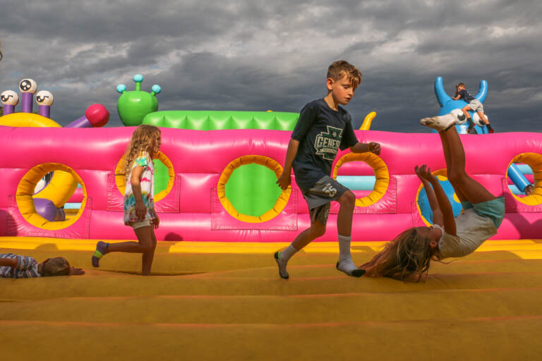 Children bounce through a space themed attraction during a press preview of Big Bounce America at the Philadelphia Navy Yard. (Emma Lee/WHYY)