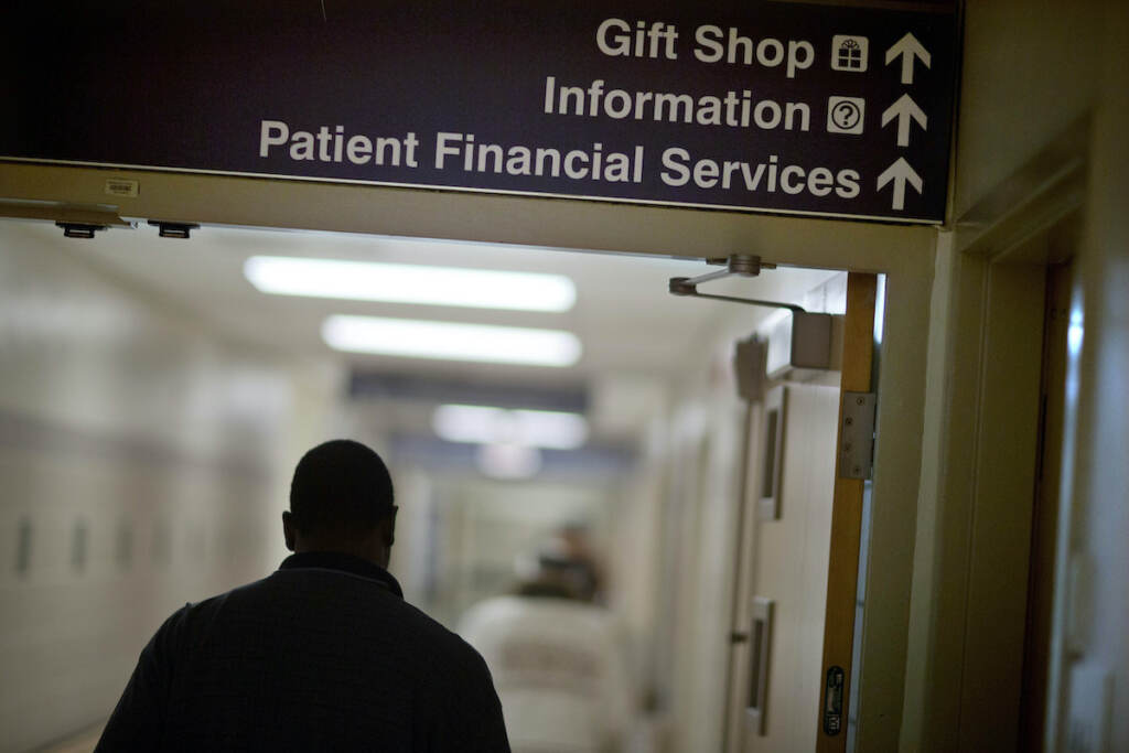 Congress Medicaid Work Requirements A sign points visitors toward the financial services department at a hospital.