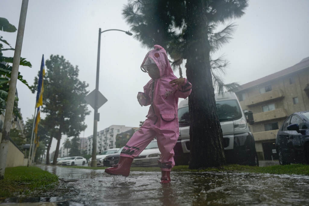 Tropical Weather A child plays in the rain, Sunday, Aug. 20, 2023, in Los Angeles.