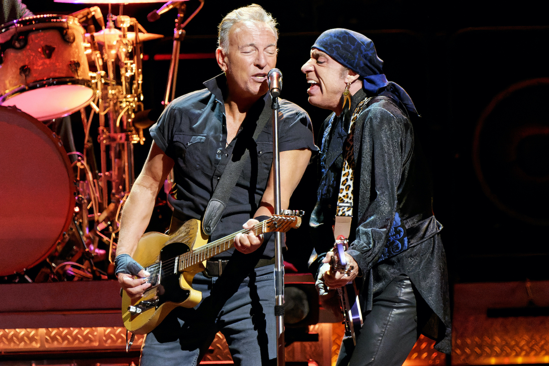 Bruce Springsteen, Steven Van Zandt Bruce Springsteen and Steven Van Zandt singing into a microphone on stage