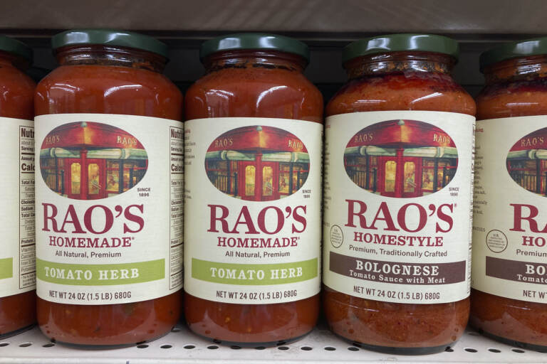 Bottles of tomato sauce on a supermarket shelf