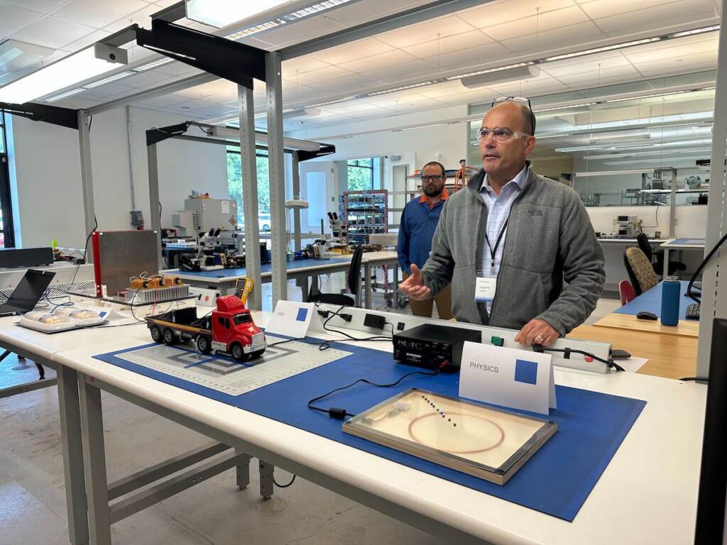 InductEV2 Jorge Rivé demonstrates the company's wireless charging system in a lab.