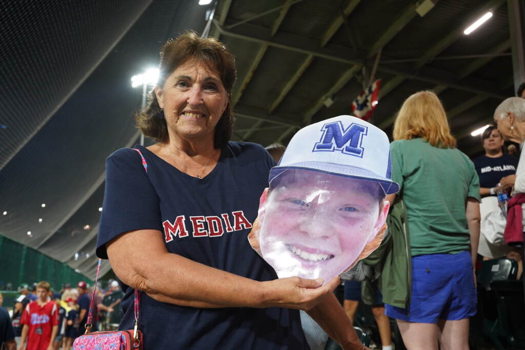 Martine Dempsey, Trevor Skowronek’s “grammy,_ holds a picture of his face following the game Marine Dempsey holds a cutout of grandson Trevor Skowronek's face at the Little League World Series