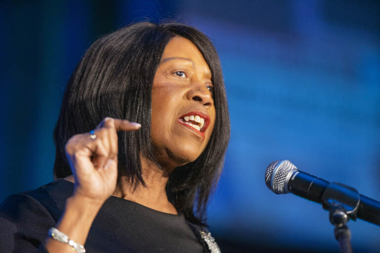 Sheila Oliver speaking into a microphone
