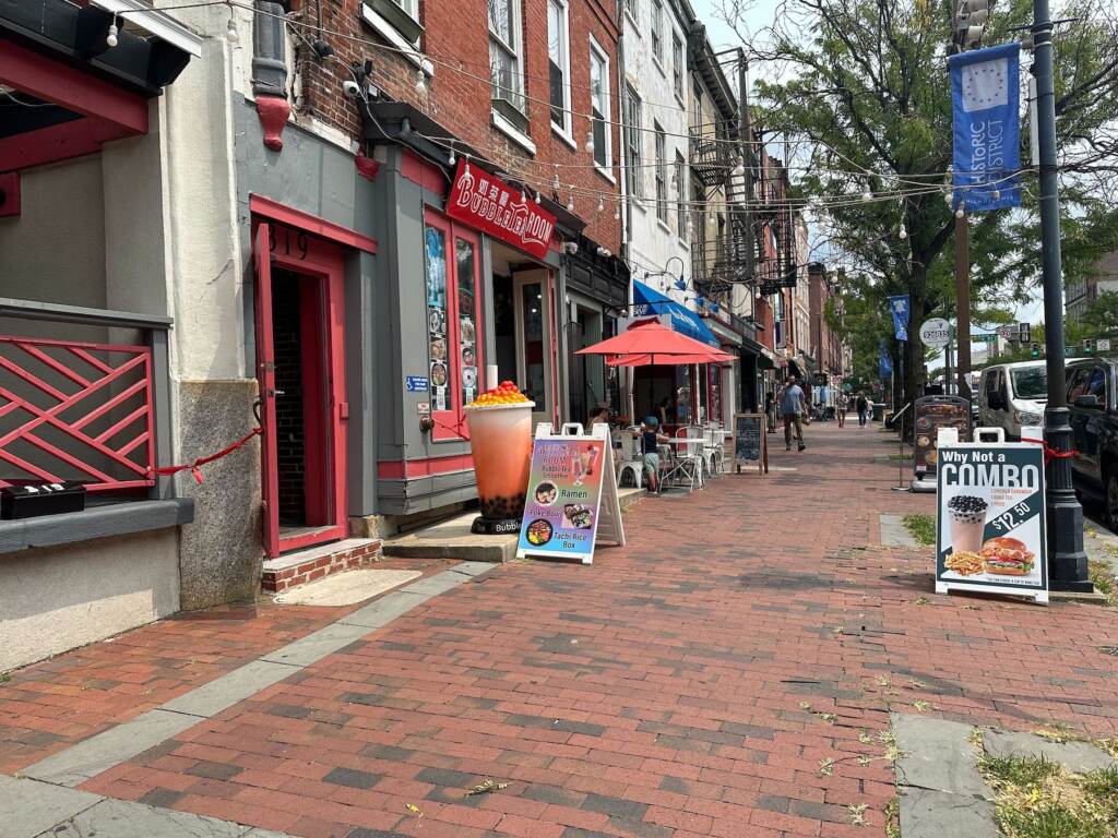 Shop windows on a busy commercial corridor.