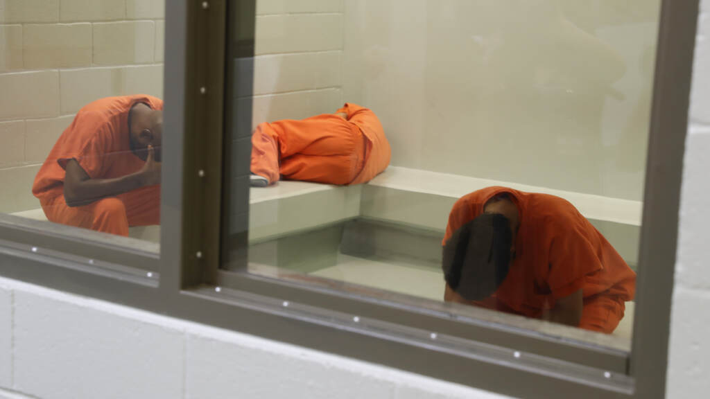 People in an ICE detention cell