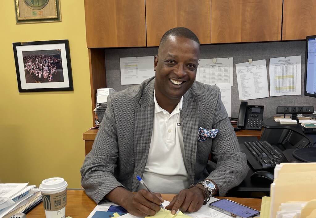Gary Officer behind his desk at the Center for Workforce Inclusion in Silver Spring, Maryland. (Alan Jinich for WHYY)