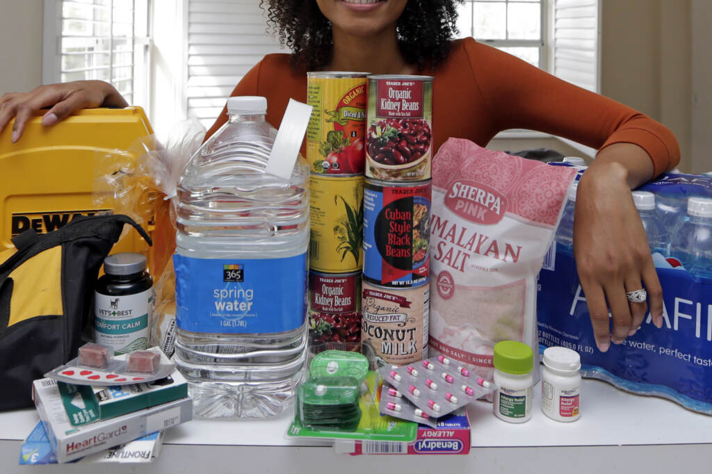 In this Friday, Sept. 29, 2017, photo, Lexi Montgomery poses with supplies she has purchased in the event of another storm, in Miami Beach, Fla. Hurricane Irma was the first hurricane that Montgomery ever experienced. In this Friday, Sept. 29, 2017, photo, Lexi Montgomery poses with supplies she has purchased in the event of another storm, in Miami Beach, Fla. Hurricane Irma was the first hurricane that Montgomery ever experienced.
