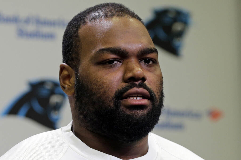 Carolina Panthers’ Michael Oher speaks to the media during their NFL football offseason conditioning program in Charlotte, N.C., on April 20, 2015. Oher, the former NFL tackle known for the movie “The Blind Side,” filed a petition Monday, Aug. 14, 2023, accusing Sean and Leigh Anne Tuohy of lying to him by having him sign papers making them his conservators, not his adoptive parents, in 2004. Michael Oher