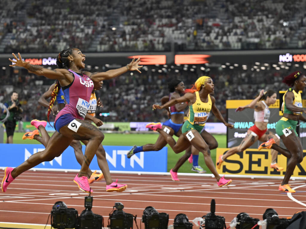 Sha’Carri Richardson, of the United States, spreads her arms as she crosses the line to win the women’s 100-meter final during the World Athletics Championships in Budapest, Hungary. Sha'Carri Richardson, of the United States, spreads her arms as she crosses the line to win the women's 100-meter final during the World Athletics Championships in Budapest, Hungary.
