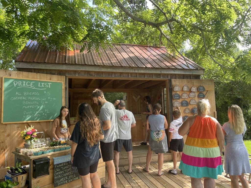 Customers stand outside of Elizabeth Degener's bread stand.