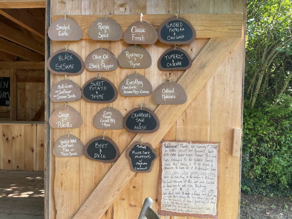 A list of bread flavors for the day are posted on the stand.