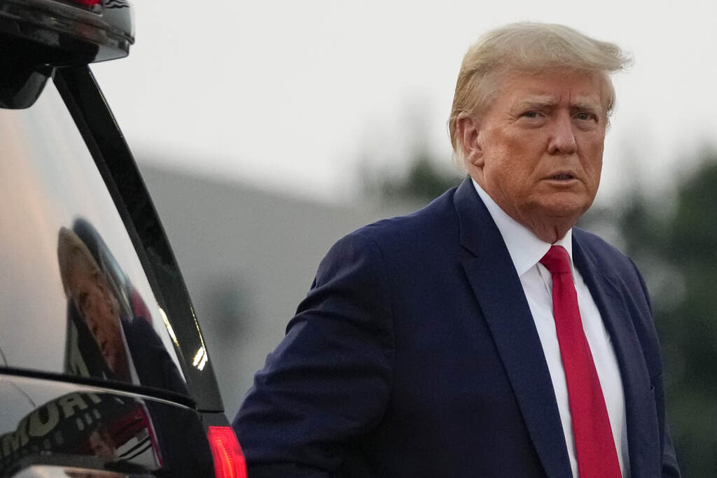 Trump Georgia Election Indictment A close-up of Donald Trump exiting a vehicle