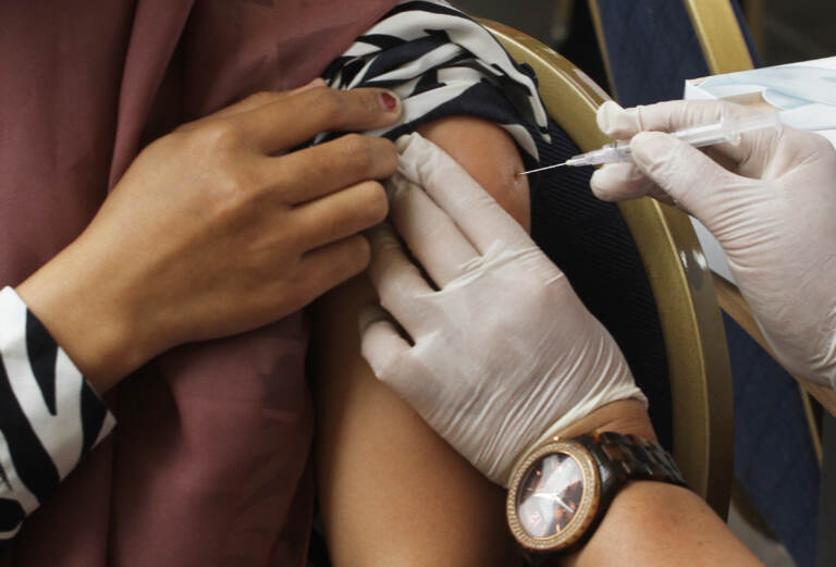 receiving a vaccine in the arm