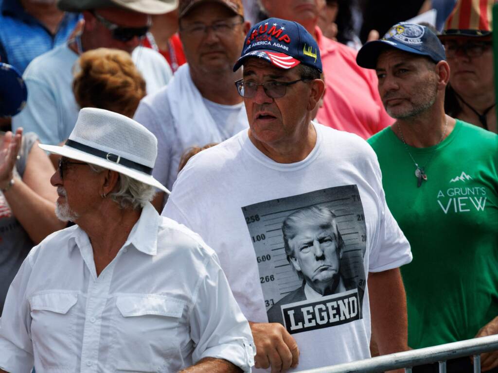 A shirt displaying a fake mug shot of the former president and 2024 presidential candidate Donald Trump is seen during a campaign rally in Pickens, S.C., in July. Trump supporter wearing a shirt with a fake Trump mugshot on it