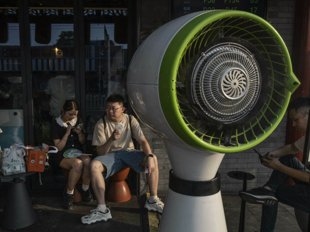 It was scorching hot across much of the planet this summer. Asia, Africa, and South America had their hottest July’s ever. Temperatures in Beijing and other parts of northern China hovered around 100 degrees Fahrenheit for weeks, with some cities topping 120 F on the worst days. 2 people sitting outside in the heat